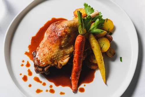 Duck confit, duck fat sautéed potatoes, baby carrots
