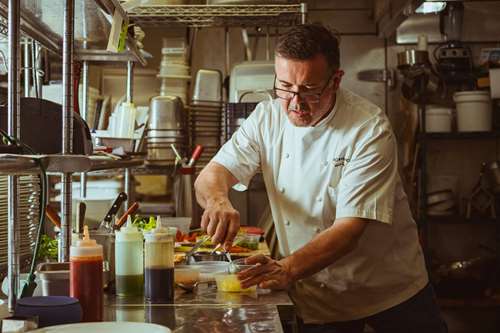 Chef Herve Mahe plating up 